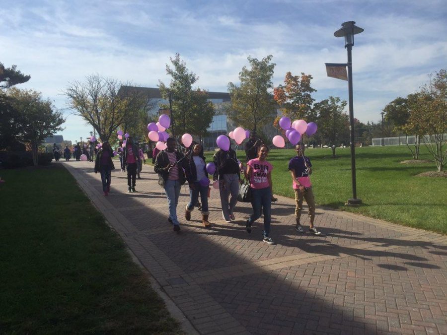 Students walk through campus to commemorate both Breast Cancer Awareness Month and Domestic Violence Awareness Month.
Photo by Maliik Obee