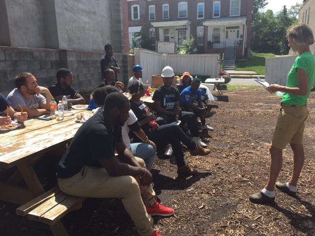 Volunteers from Morgan State University and Johns Hopkins University take a lunch break and learn about Habitat for Humanity.
Photo by Jazmine Hawes.