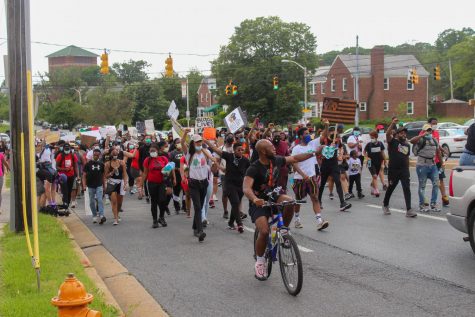 Hundreds of protesters march down Hillen Road Saturday afternoon.