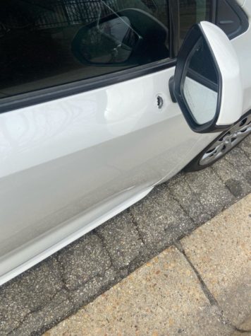 Pictured: Pinder’s 2020 Toyota Corolla with a 9mm bullet hole through its door