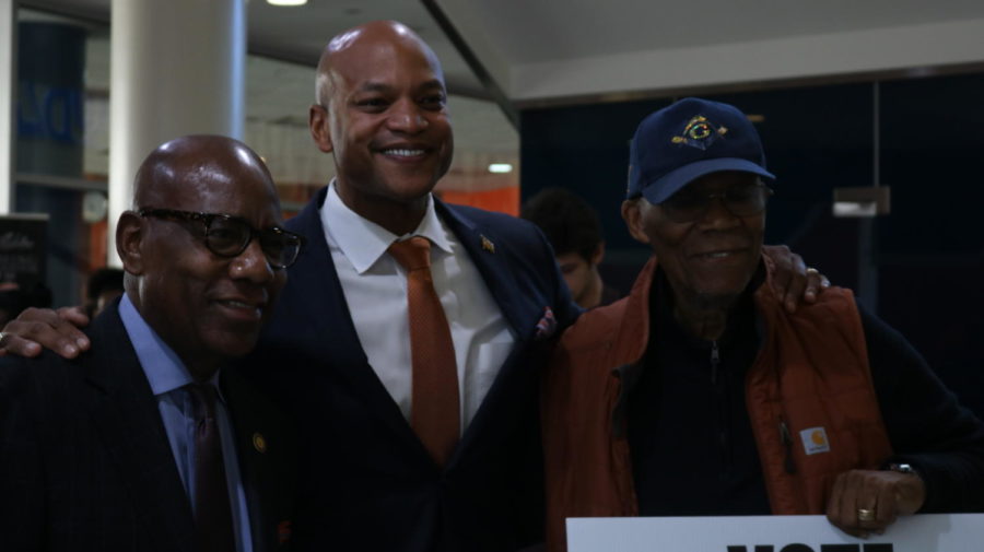 Wes Moore poses with University President David Wilson and Larry Gibson.