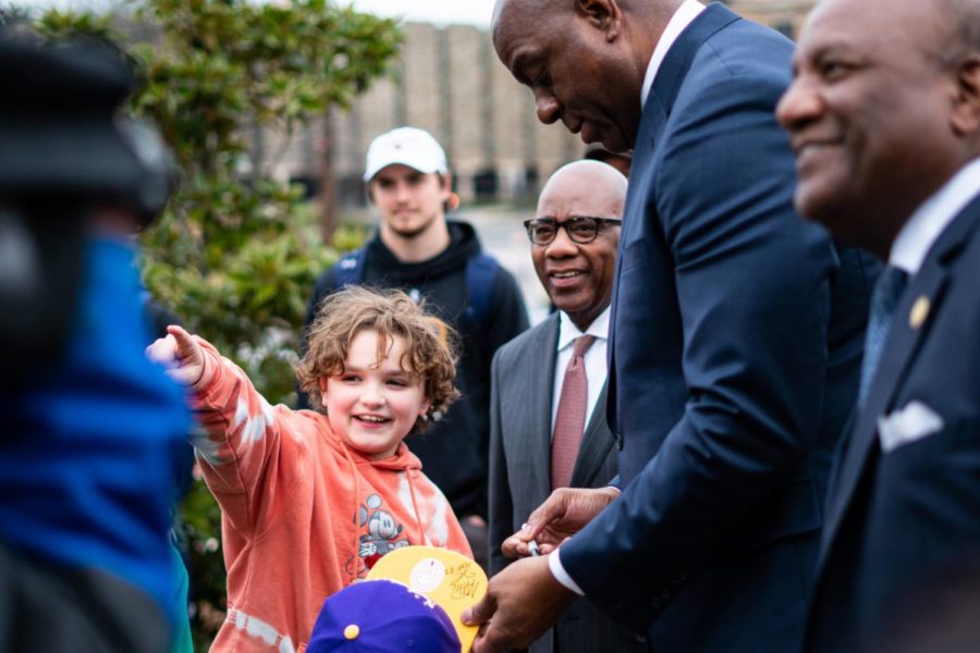 Magic Johnson signs the hat of fan at Morgan State University | February 20, 2023.