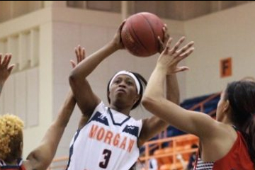 Sophomore forward Tykyrah Williams attempts a shot while contested by Lady Bison.