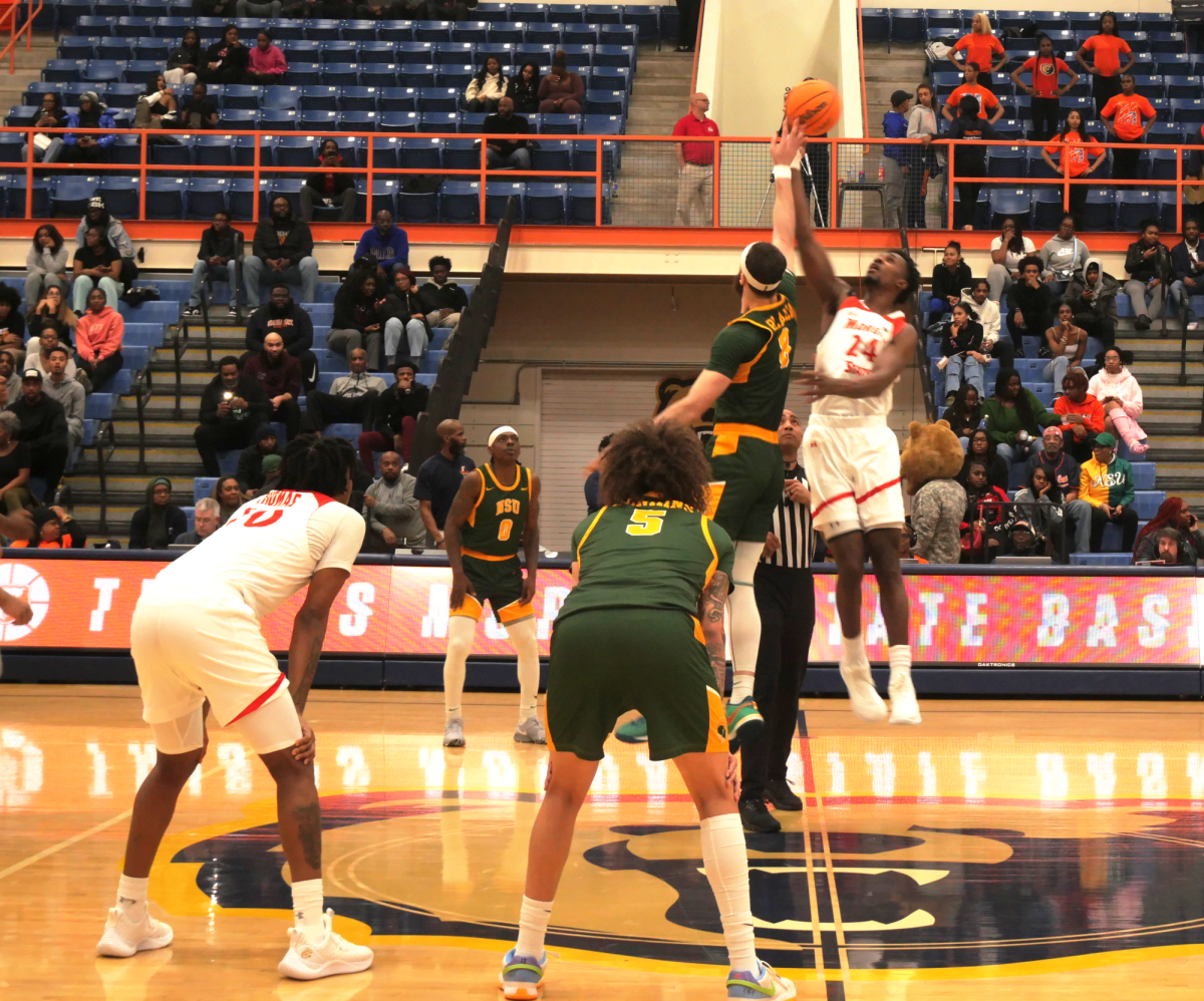 Allen Udemadu junior forward goes tries to win the tip off in a game against Norfolk State Spartans on Feb. 26 in Hill Field House.