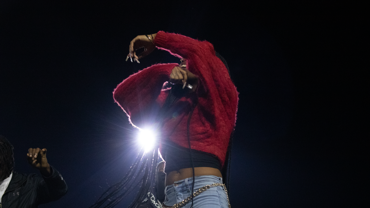 An artist performs before an audience during the homecoming pep rally at Hughes Memorial Stadium on Oct. 7, 2022.