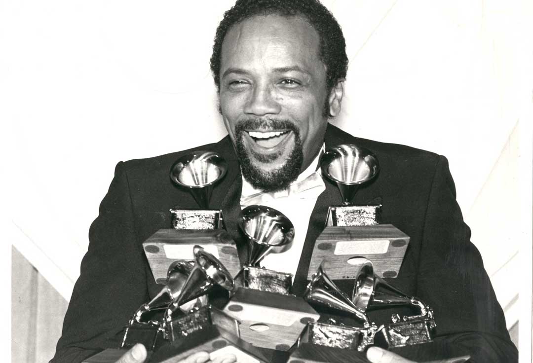 Quincy Jones holds numerous Grammys following the 1990 awards ceremony.