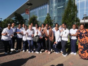 President David K. Wilson posing with nursing students 