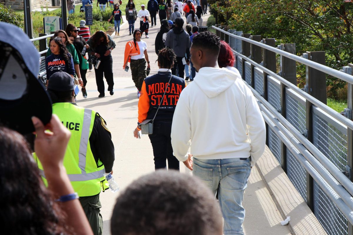 Morgan State University alumni cross the university’s Cold Spring Lane pedestrian bridge on campus.