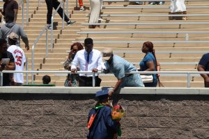 A graduate celebrates with family 