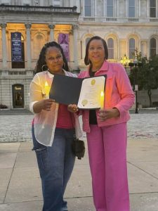 Angela Evans (left) and Janet Hall receiving a mayoral proclamation for their foundation's work in supporting breast cancer survivors